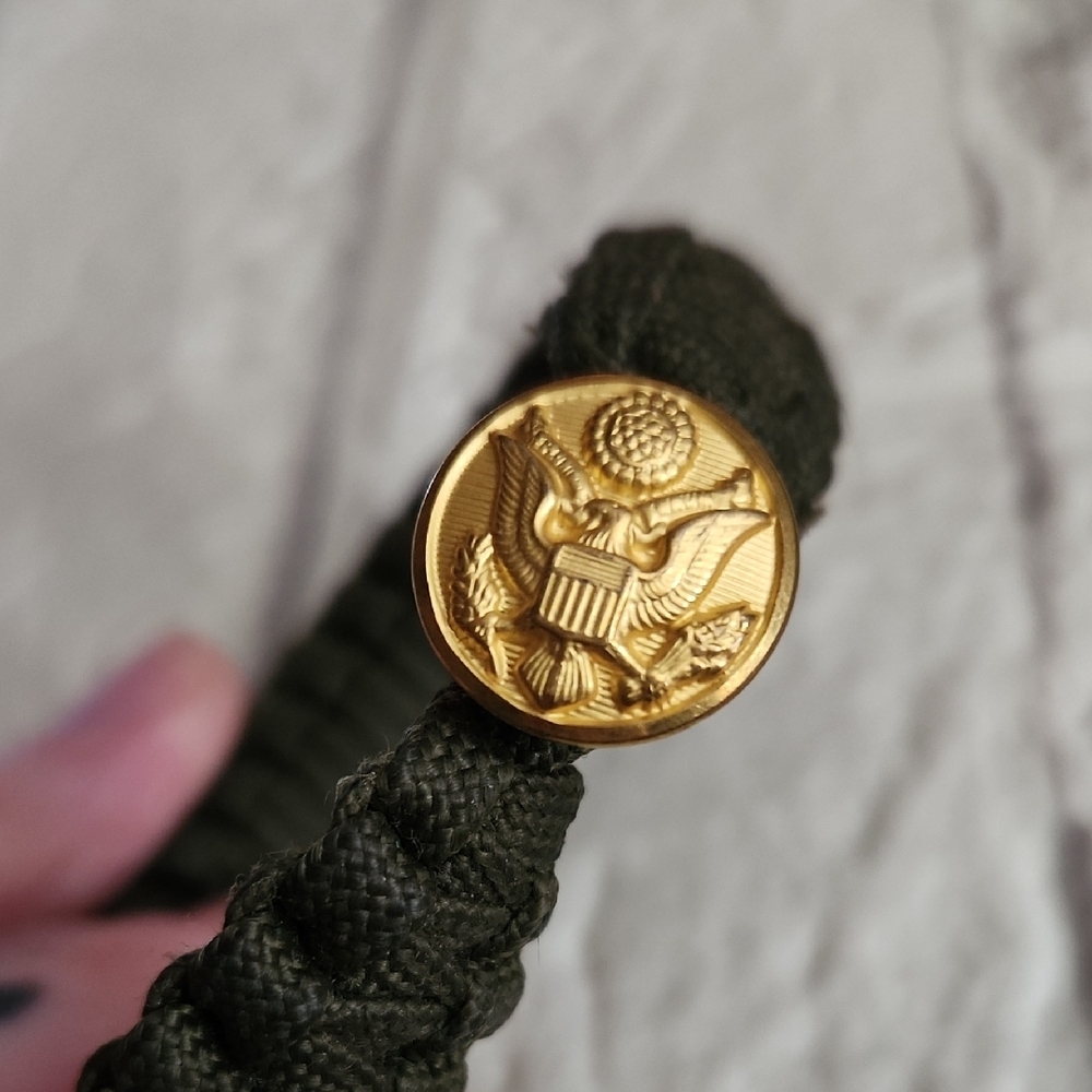 Gold Emblem on Green Braided Bracelet